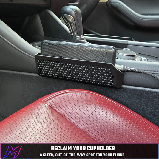 MATERIUM phone holder mounted in Mazda3 center console with phone in place — Reclaim Your Cupholder, a sleek out-of-the-way spot for your phone