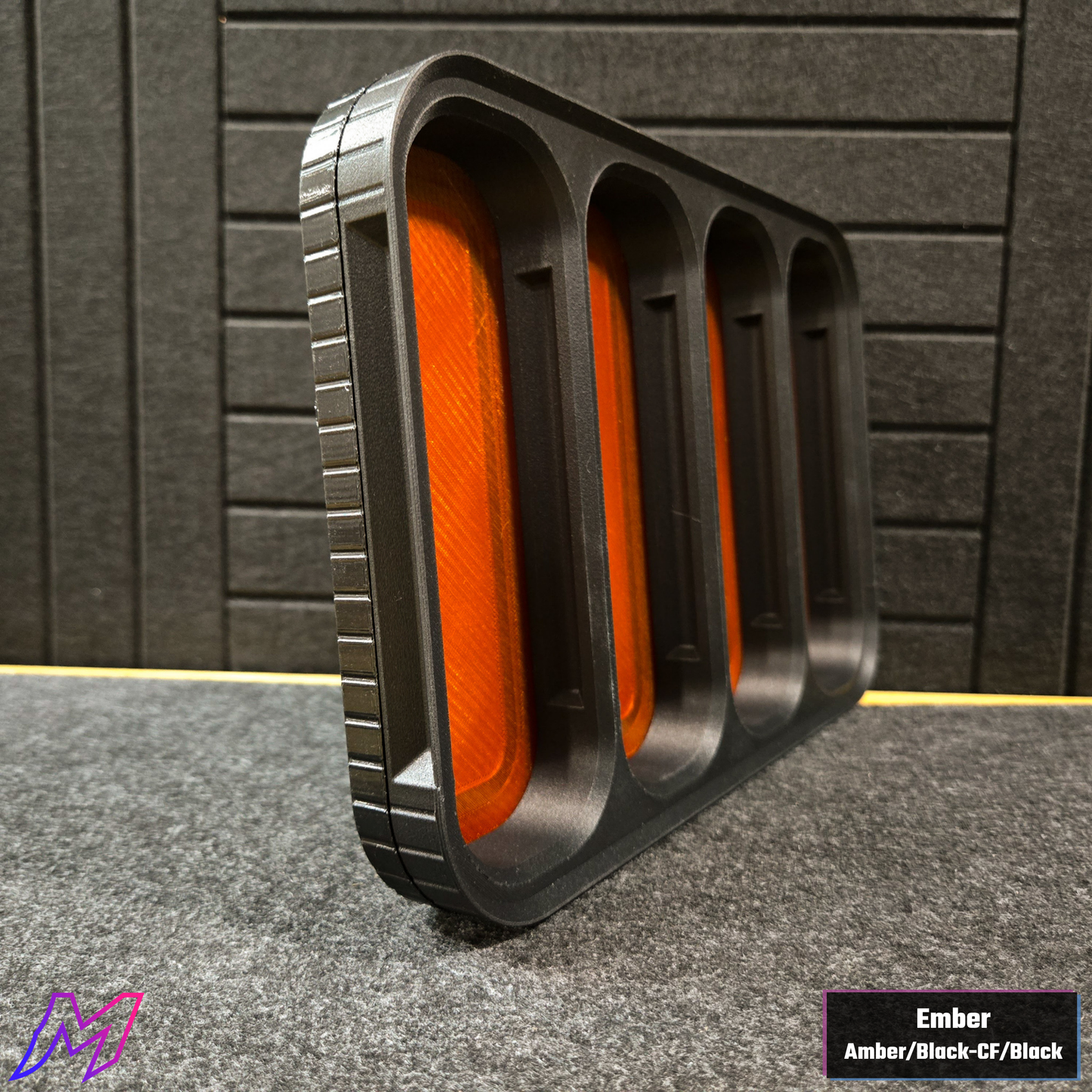 MATERIUM Vanguard Catch Ember colorway side profile showing ribbed black exterior and amber resin interior glow