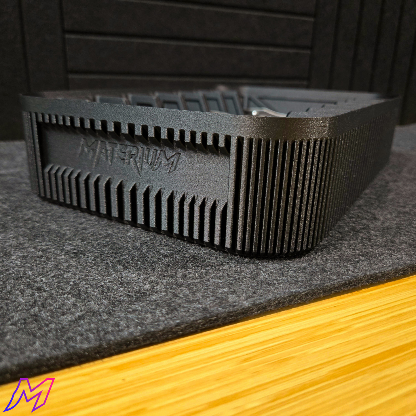 MATERIUM Vanguard Array Series 1 rear view, ribbed matte black exterior with debossed MATERIUM branding