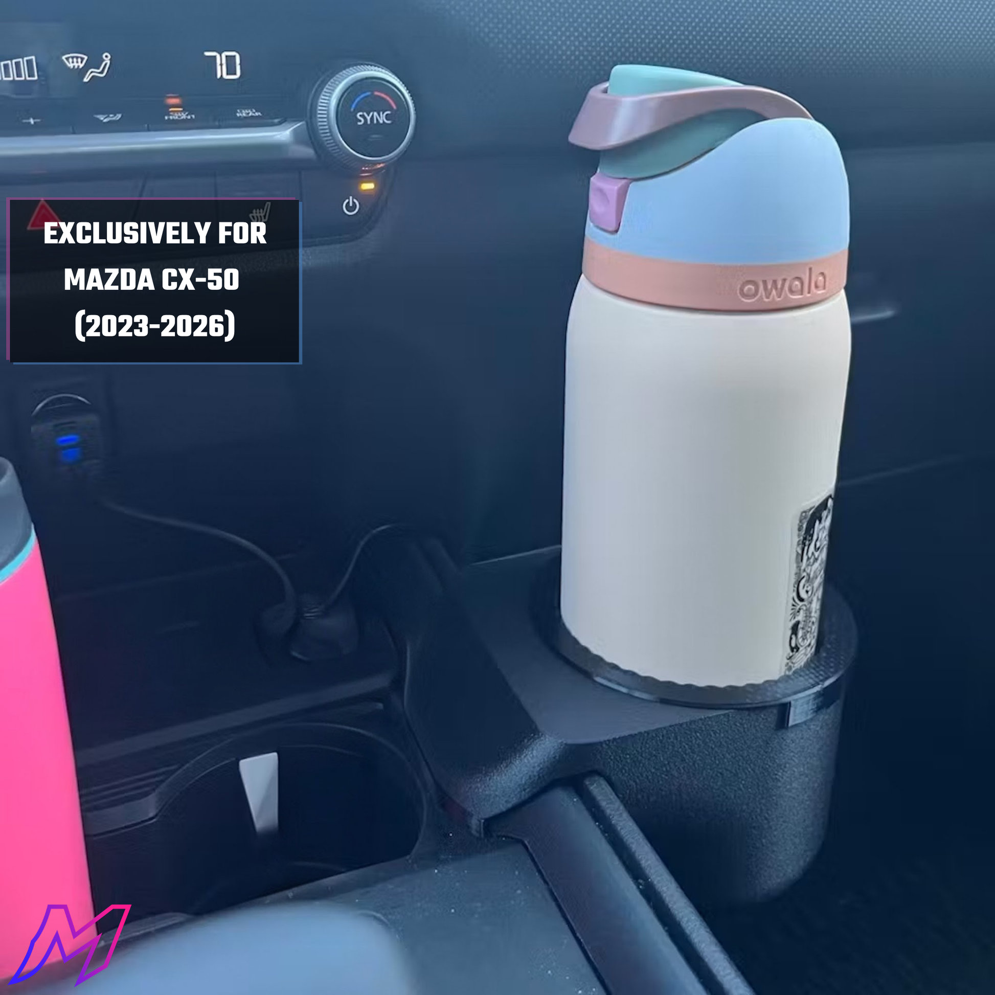 Owala water bottle in a car cup holder with Mazda CX-50 compatibility label.