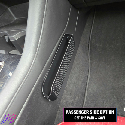 Car interior with a carbon fiber patterned panel on the passenger side