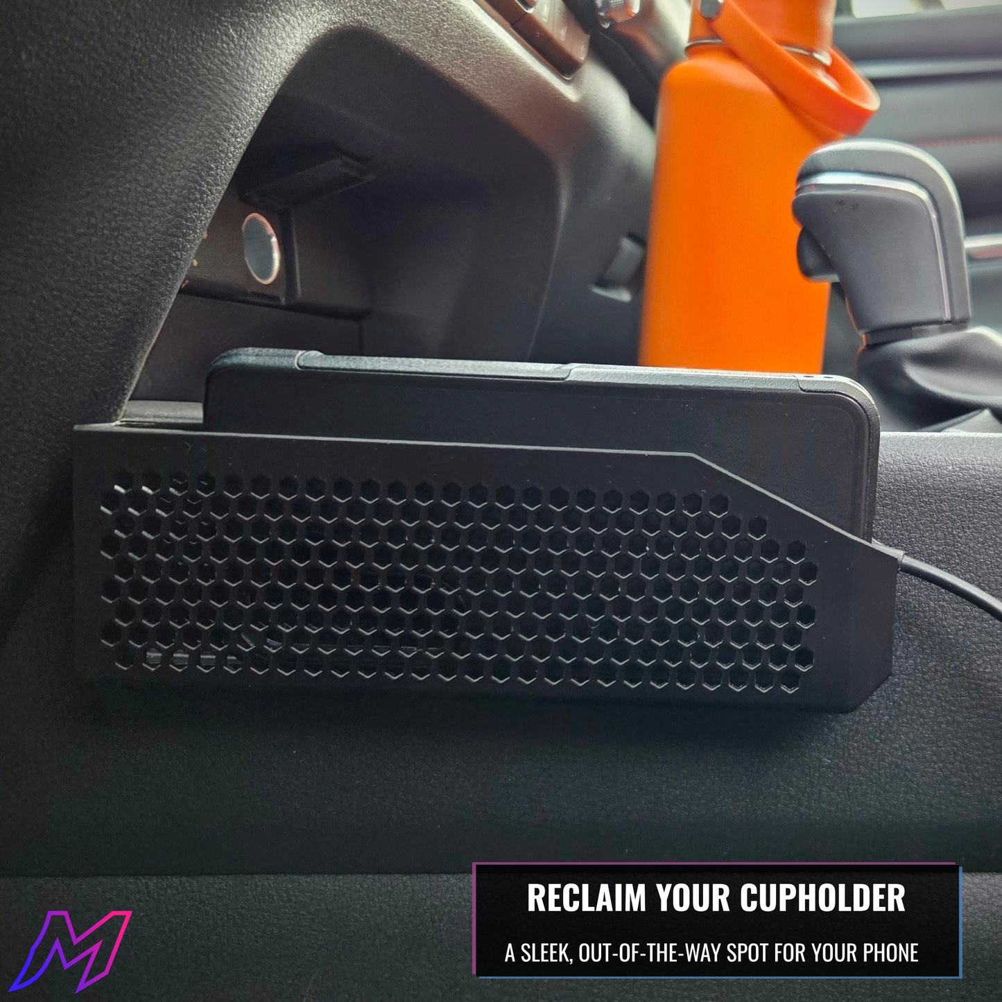 MATERIUM CX-50 phone holder installed in console gap with phone loaded, reclaim your cupholder